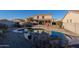 Relaxing kidney-shaped pool with surrounding patio and waterfall feature at 1647 W Gold Mine Way, San Tan Valley, AZ 85144