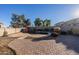 Spacious backyard with a relaxing kidney-shaped pool and patio at 1647 W Gold Mine Way, San Tan Valley, AZ 85144