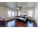 Primary bedroom with wood floors and ceiling fan at 1647 W Gold Mine Way, San Tan Valley, AZ 85144