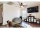 Bedroom with large TV, beanbag chair, and ceiling fan at 1647 W Gold Mine Way, San Tan Valley, AZ 85144