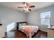 Bright bedroom with wood floors and ceiling fan at 1647 W Gold Mine Way, San Tan Valley, AZ 85144