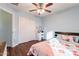 Bedroom with wood floors, double closet, and ceiling fan at 1647 W Gold Mine Way, San Tan Valley, AZ 85144