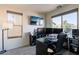 Home office featuring a large desk, multiple monitors, and ample natural light at 1647 W Gold Mine Way, San Tan Valley, AZ 85144