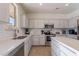 Modern kitchen with white cabinets and quartz countertops at 1647 W Gold Mine Way, San Tan Valley, AZ 85144