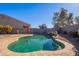 Relaxing kidney-shaped pool surrounded by a patio at 1647 W Gold Mine Way, San Tan Valley, AZ 85144