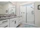 Bathroom with granite vanity, large shower, and white tile at 16747 W Cielo Grande Ave, Surprise, AZ 85387