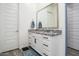 Bathroom with granite countertop, single sink, and large mirror at 16747 W Cielo Grande Ave, Surprise, AZ 85387