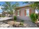 Side view of the home showcasing its stucco exterior and landscaping at 16747 W Cielo Grande Ave, Surprise, AZ 85387