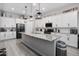 Modern kitchen with white cabinets, granite counters, and stainless steel appliances at 16747 W Cielo Grande Ave, Surprise, AZ 85387