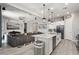 Open concept kitchen with island, granite countertops, and views into living room at 16747 W Cielo Grande Ave, Surprise, AZ 85387