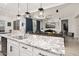 Kitchen island with granite countertop and dual sinks overlooking living room at 16747 W Cielo Grande Ave, Surprise, AZ 85387