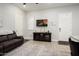 Living room with brown sofa and TV at 16747 W Cielo Grande Ave, Surprise, AZ 85387