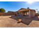 Large backyard with gravel and covered patio at 17528 W East Wind Ave, Goodyear, AZ 85338