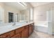 Double vanity bathroom with soaking tub and shower at 17528 W East Wind Ave, Goodyear, AZ 85338