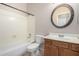 Bathroom with tub, toilet, vanity, and decorative mirror at 17528 W East Wind Ave, Goodyear, AZ 85338