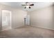 Spacious bedroom with ensuite bathroom access and ceiling fan at 17528 W East Wind Ave, Goodyear, AZ 85338