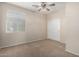 Well-lit bedroom with carpet, window coverings, and closet at 17528 W East Wind Ave, Goodyear, AZ 85338