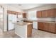 Kitchen with light wood cabinets, an island, and tile floors at 17528 W East Wind Ave, Goodyear, AZ 85338