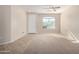 Living room with tile and carpeted floors, and a large window at 17528 W East Wind Ave, Goodyear, AZ 85338