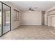 Living room with patio access, tile floors, and built-in shelving at 17528 W East Wind Ave, Goodyear, AZ 85338