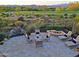 Relaxing backyard patio with fire pit and water feature at 17716 E Silver Sage Ln, Rio Verde, AZ 85263