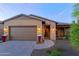 A charming single story home with a brown garage door and welcoming entryway at 17716 E Silver Sage Ln, Rio Verde, AZ 85263