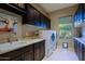 Laundry room with dark cabinets, a sink, and washer/dryer at 17716 E Silver Sage Ln, Rio Verde, AZ 85263