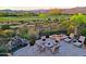 Large patio with fire pit and waterfall feature at 17716 E Silver Sage Ln, Rio Verde, AZ 85263