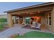 Relaxing covered patio with seating area, views of the mountains, and access to the interior at 17716 E Silver Sage Ln, Rio Verde, AZ 85263