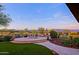 Elegant patio with fire pit and mountain views at 17716 E Silver Sage Ln, Rio Verde, AZ 85263