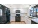 Modern kitchen featuring black appliances and white cabinetry at 1834 W Kerry Ln, Phoenix, AZ 85027