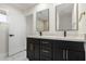 Bathroom with double vanity and modern dark wood cabinets at 1936 E Cornell Dr, Tempe, AZ 85283