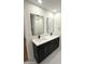 Modern bathroom with double vanity, quartz countertop, and black cabinets at 1936 E Cornell Dr, Tempe, AZ 85283