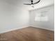 Bright bedroom featuring wood-look floors and ceiling fan at 1936 E Cornell Dr, Tempe, AZ 85283