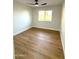 Bright bedroom with wood-look flooring and a window with blinds at 1936 E Cornell Dr, Tempe, AZ 85283