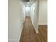 Bright hallway with light brown laminate flooring and white doors at 1936 E Cornell Dr, Tempe, AZ 85283