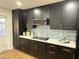 Modern kitchen with dark cabinets and white quartz countertops at 1936 E Cornell Dr, Tempe, AZ 85283