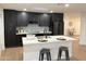 Modern kitchen with dark cabinetry, white countertops, and island at 1936 E Cornell Dr, Tempe, AZ 85283