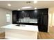 Modern kitchen with dark cabinetry, marble countertops, and stainless steel appliances at 1936 E Cornell Dr, Tempe, AZ 85283