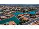 Aerial perspective of a residential area with houses situated around a central lake at 19847 N 108Th Ave, Peoria, AZ 85373