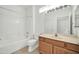 Bright bathroom with a shower/tub combo and wood vanity at 19847 N 108Th Ave, Peoria, AZ 85373