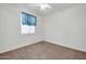 Bright bedroom with ceiling fan and neutral carpeting at 19847 N 108Th Ave, Peoria, AZ 85373