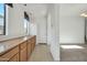 Hallway with wood cabinets and tile floor at 19847 N 108Th Ave, Peoria, AZ 85373