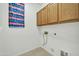 Laundry room with wood cabinets and built in shelving at 19847 N 108Th Ave, Peoria, AZ 85373