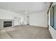 Living room with fireplace, carpet, and large window at 19847 N 108Th Ave, Peoria, AZ 85373