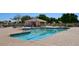 Community swimming pool with a shaded seating area at 19847 N 108Th Ave, Peoria, AZ 85373