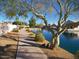 Scenic walkway along a tranquil lake with lush landscaping at 19847 N 108Th Ave, Peoria, AZ 85373