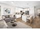 Living room with open concept kitchen and gray sectional sofa at 20752 N 223Rd Ave, Surprise, AZ 85387