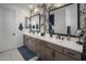 Elegant bathroom with double vanity, large mirror, and stylish wallpaper at 22034 N 59Th Pl, Phoenix, AZ 85054