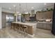 Modern kitchen with large island, stainless steel appliances, and wood cabinets at 22034 N 59Th Pl, Phoenix, AZ 85054